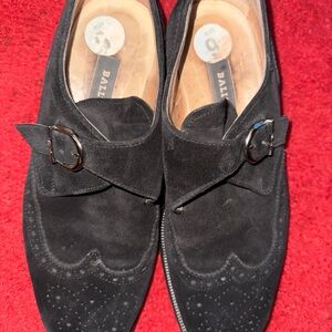 Buckled suede wing tip shoes